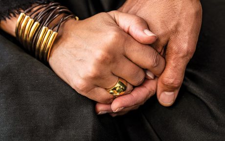 Photo of the clasped hands of Tricia Rose and Andre Willis